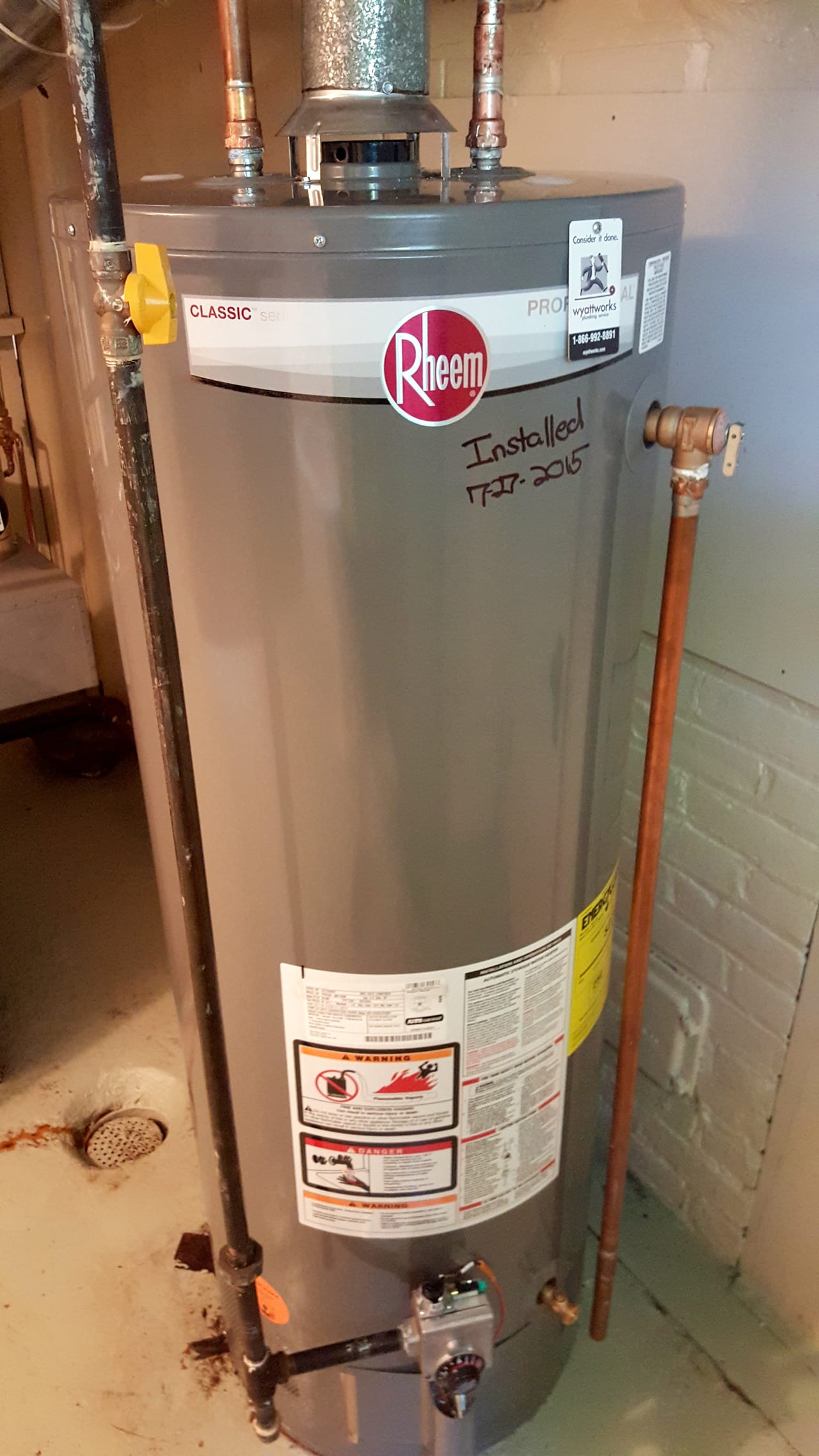 Residential gas water heater with visible pipe connections